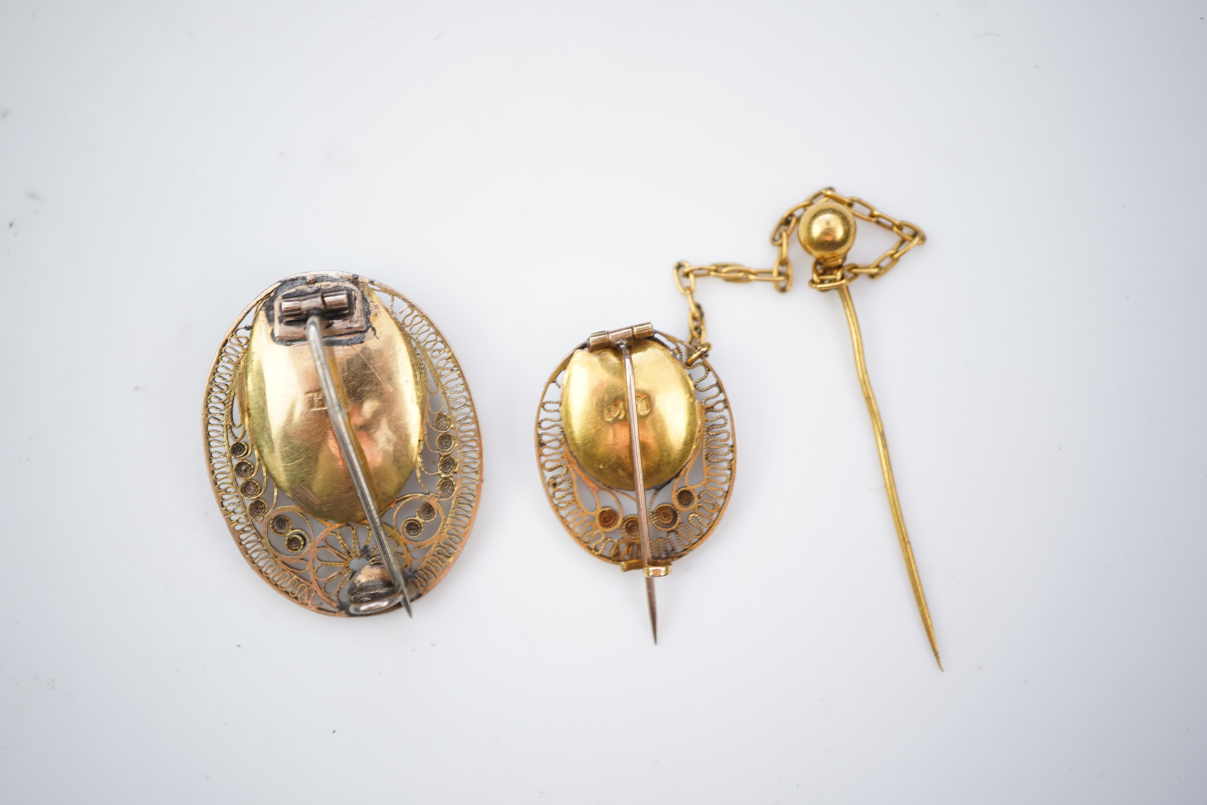 A collection of shell cameo brooches, comprising: a cameo depicting Bacchus, in a gold mount in the Archaeological Revival style, decorated with rope twist and a twisted knife wire border, length 4.4cm; together with sev